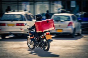 African people  delivery man on a motorcycle