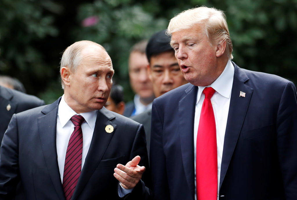 U.S. President Donald Trump and Russia's President Vladimir Putin talk during the family photo session at the APEC Summit in Danang, Vietnam